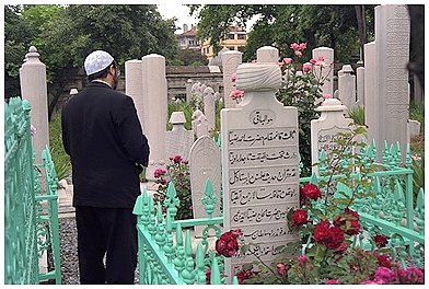 un fedele in preghiera al cimitero